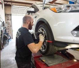 Joshua Derham working on tires at Derham's Alignment Auto Repair Shop in Wilmington NC