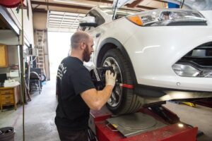 Tire Rotation- Joshua Derham working on tires at Derham's Alignment Auto Repair Shop in Wilmington NC