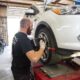 Joshua Derham working on tires at Derham's Alignment Auto Repair Shop in Wilmington NC