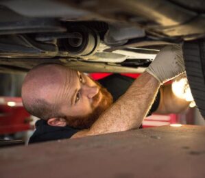 Joshua Derham, an alignment specialist, working on a car at Derham's Alignment & Brake Center in Wilmington, NC.